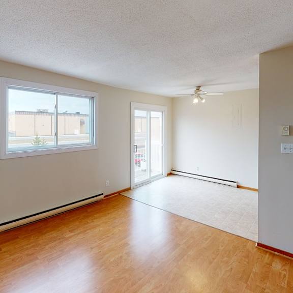 a room with wooden floors and a window.
