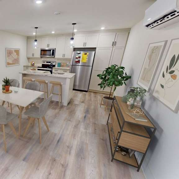 a modern open plan living and kitchen area with a dining table and chairs.