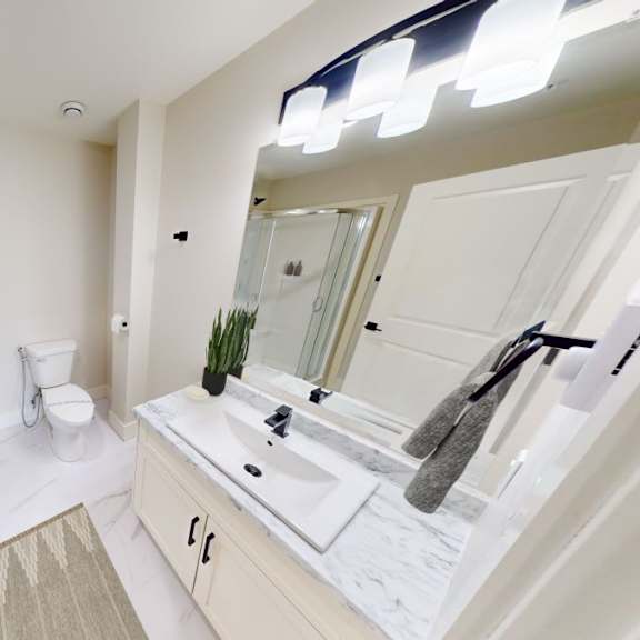a modern bathroom with a glass shower stall and a sink vanity.
