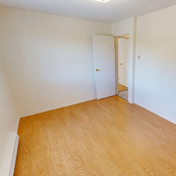 a room with a wooden floor and a door.