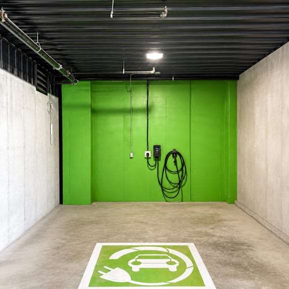a parking space with a green sign on the floor.