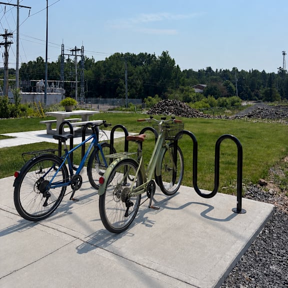 two bicycles are parked next to each other on a concrete platform.