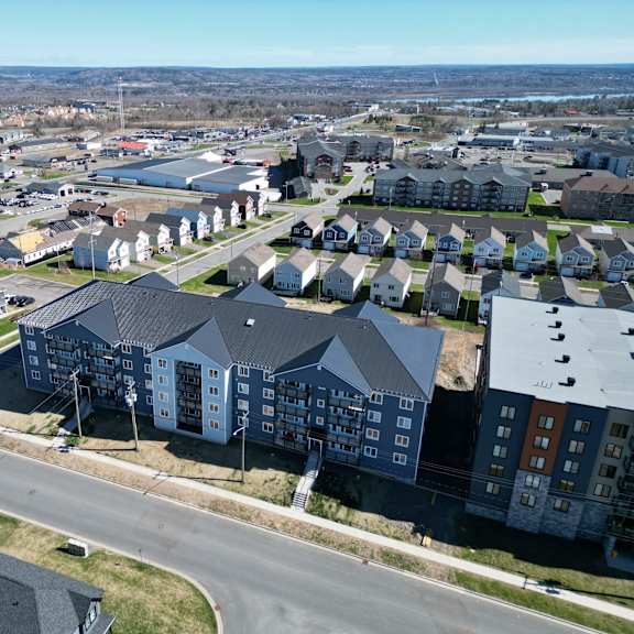 a large apartment complex sits in the middle of a suburban neighborhood.
