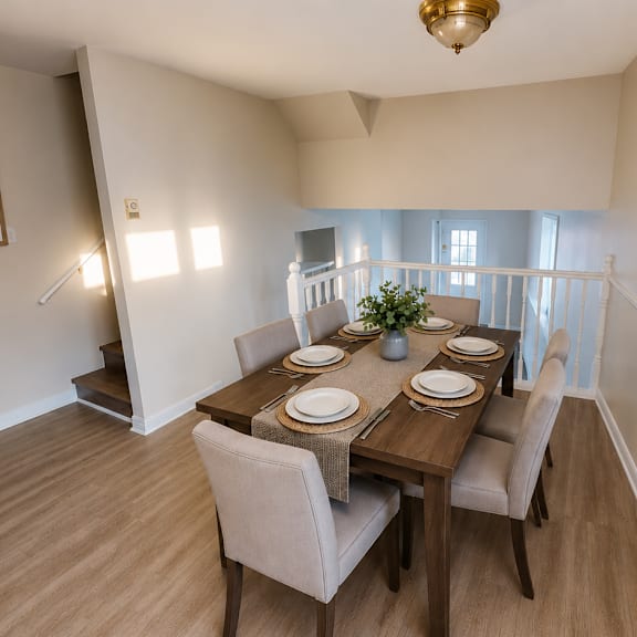 a dining room with a wooden table set for two.
