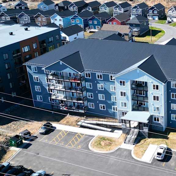 a large building with a parking lot in front of it.