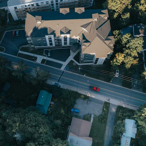 a bird's eye view of a road with a car stopped at a red light.