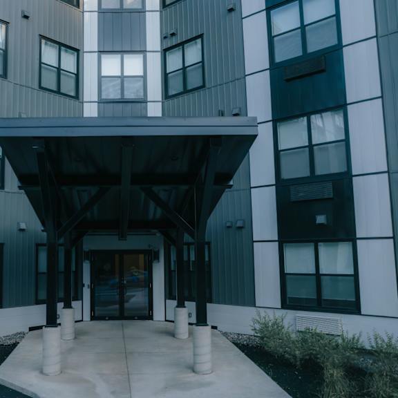 a modern building with a central entrance and a black and white color scheme.