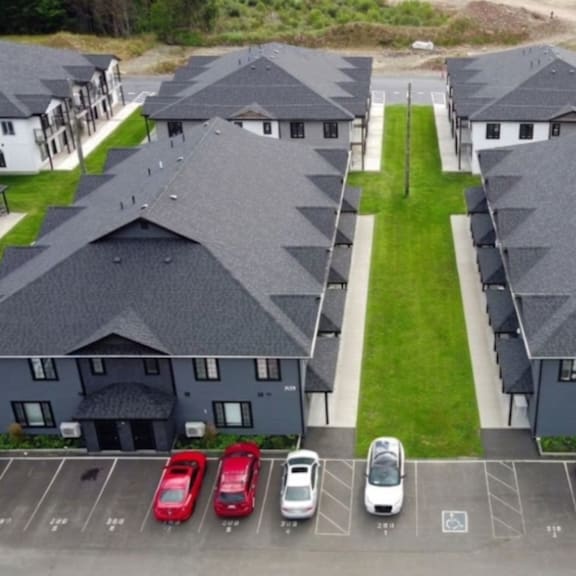 a parking lot with cars in front of a building.