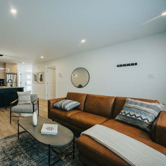 a living room with a brown couch and a coffee table.