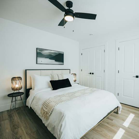 a bedroom with a large bed and a ceiling fan.