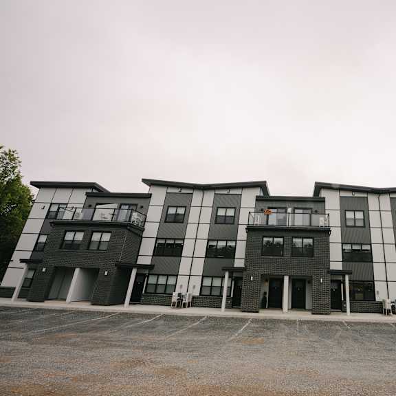 a large, modern building with black and white balconies.