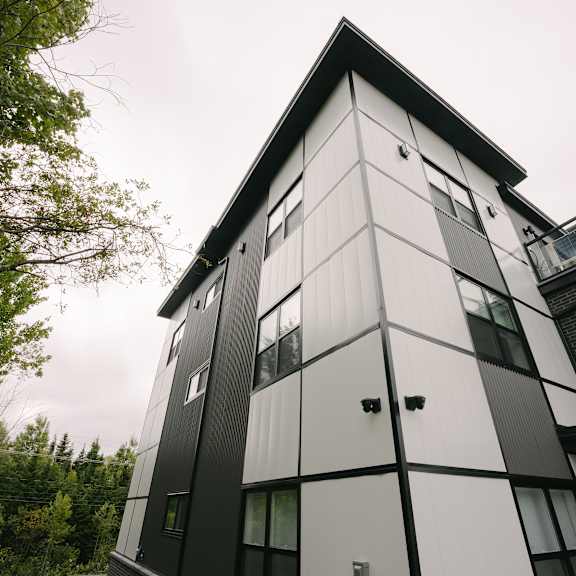 a modern black and white building with a triangular roof.