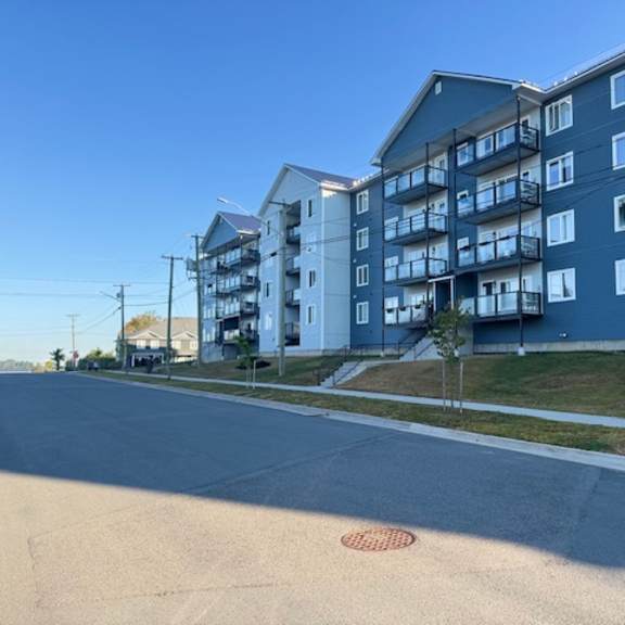 a street view of a residential area with apartment buildings.