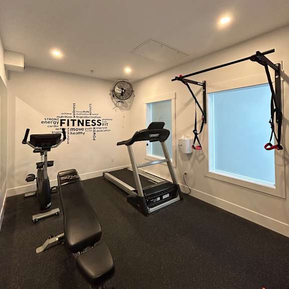a gym with a pull up bar and a mirror.