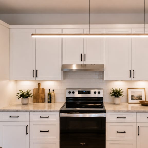 a modern kitchen with white cabinets and a stainless steel refrigerator.