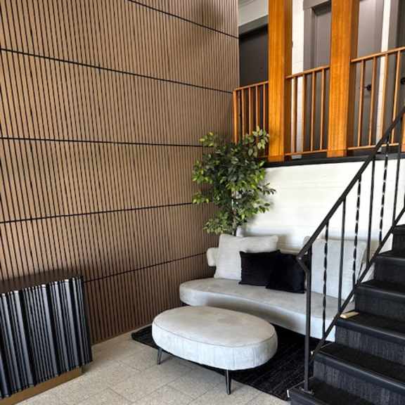a potted plant sits on a tiled floor next to a white chair.