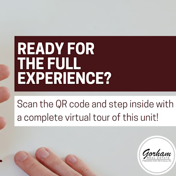 a hand holding a smartphone displaying a qr code with the text