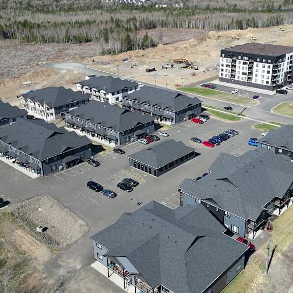 a large, modern housing complex with multiple buildings and parking lots.
