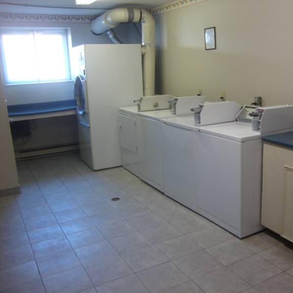 a kitchen with a white dishwasher and a sink.