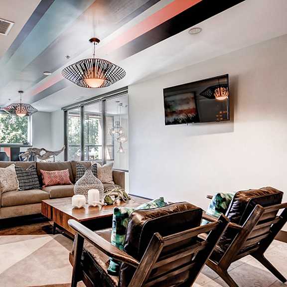 a modern living room with a wooden table and chairs.