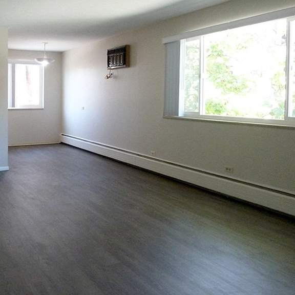 a room with wooden floors and white walls.