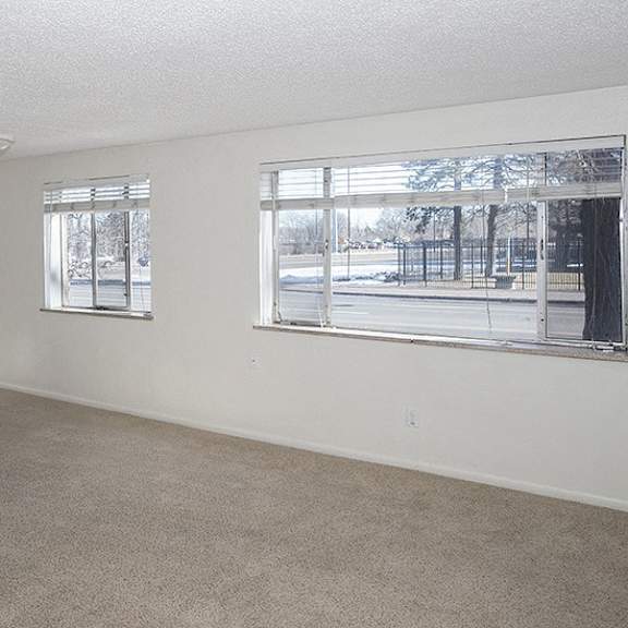 a room with a window and a door leading to a hallway.