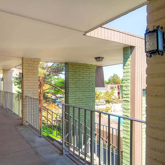 a long hallway with a balcony on the right side.