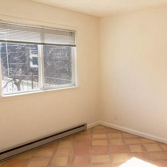 a room with a window and a tiled floor.