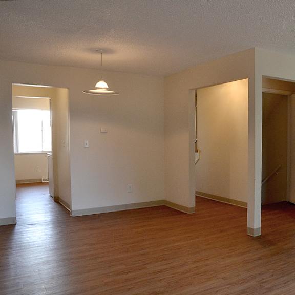 a room with wooden floors and white walls.