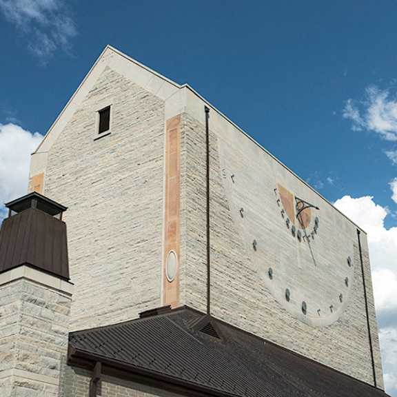 a large clock is on the side of a building.