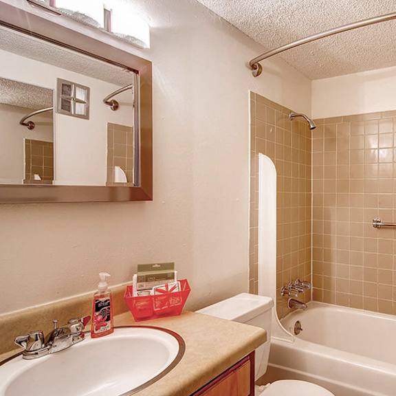 a bathroom with a white tub and a sink.