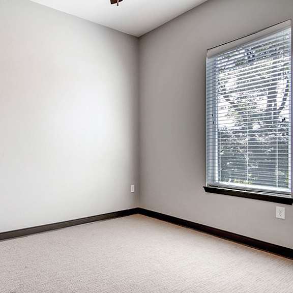 a room with a window covered by blinds.