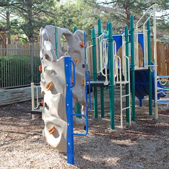 a playground with a blue and white slide.
