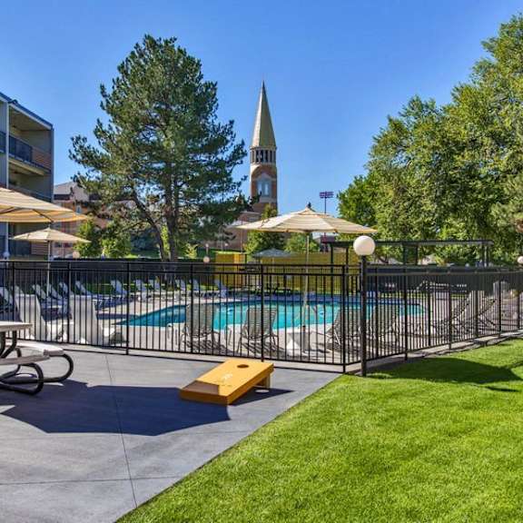 a pool area with a table and chairs and a bicycle.