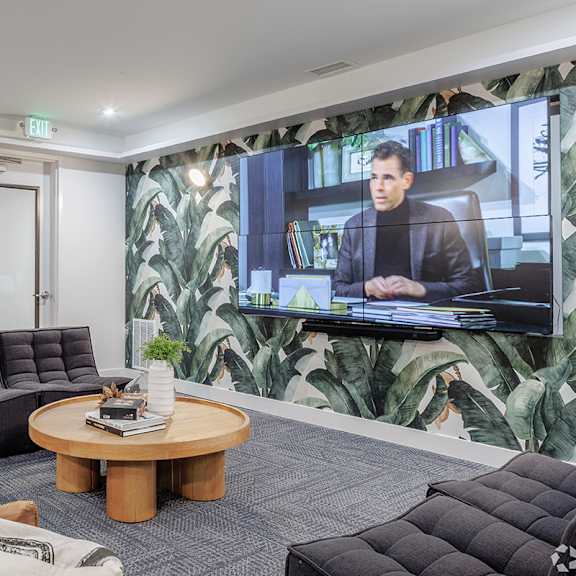 a man is on a television screen in a living room.