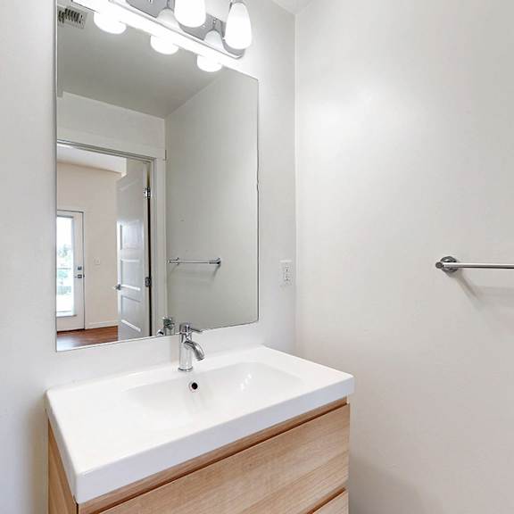 a bathroom with a sink and mirror.