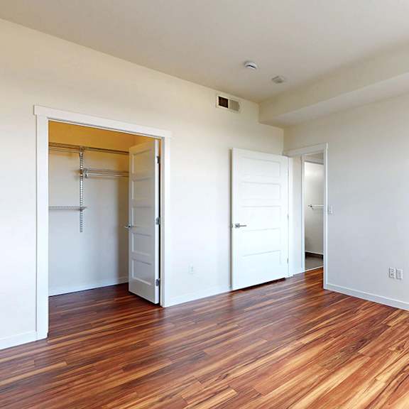 a room with wooden floors and white walls.