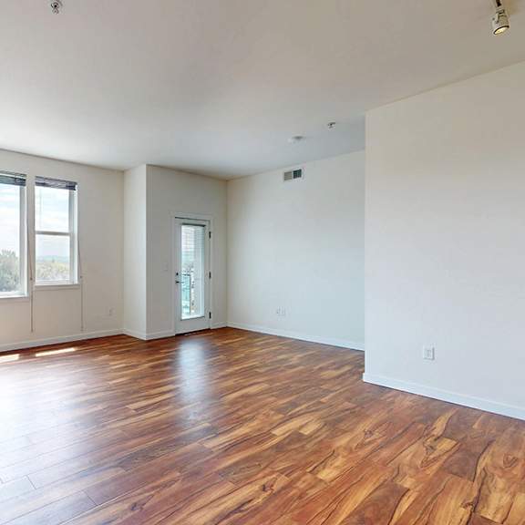 a room with wooden floors and white walls.