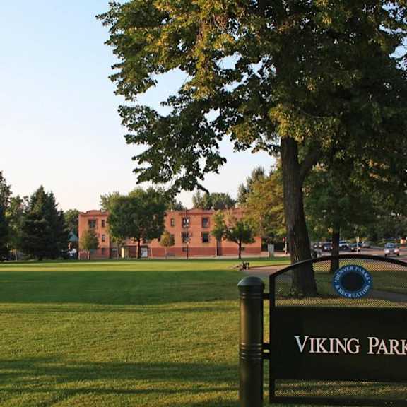 a sign in front of a tree reads viking park.