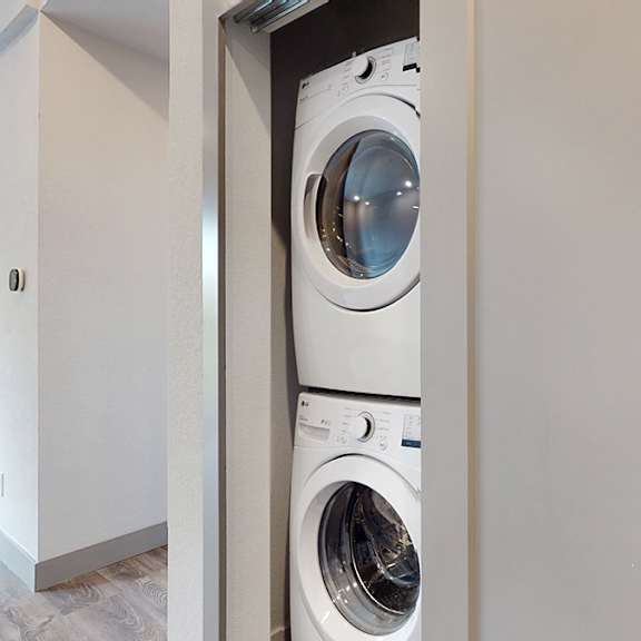 a white washing machine is in a small space.