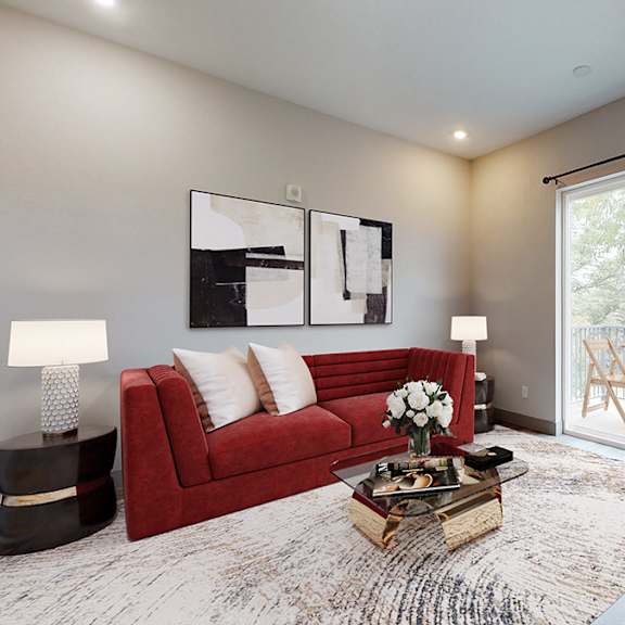 a living room with a red couch and a coffee table.