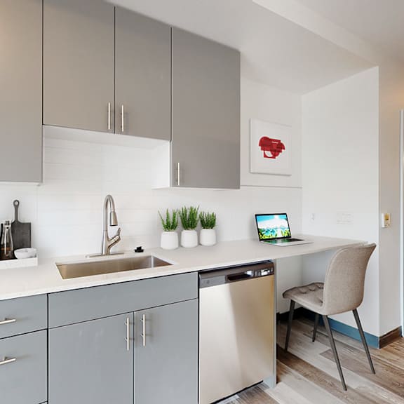 a modern kitchen with a microwave, oven, and a sink.
