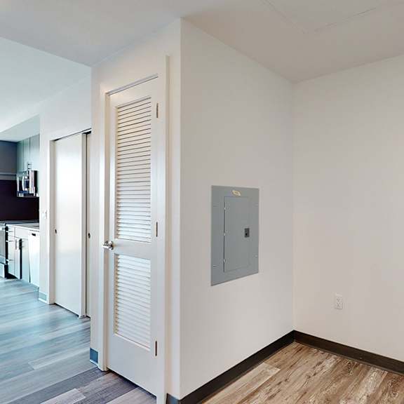 a white door with a silver handle is on the right side of the image.