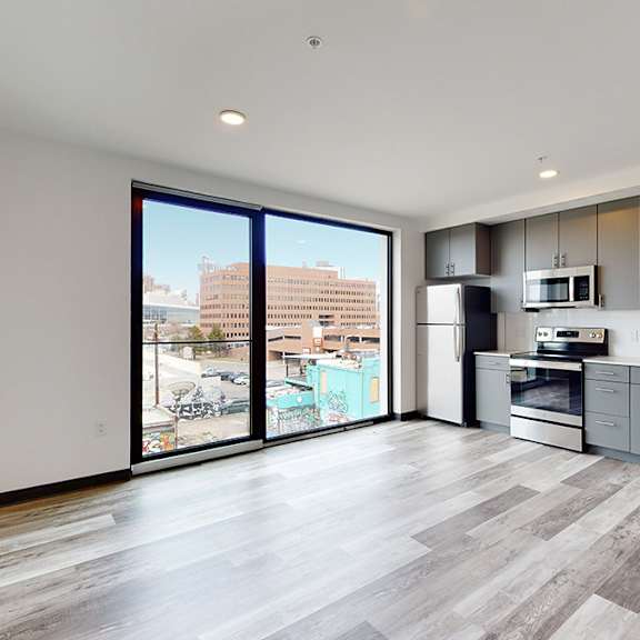 a modern kitchen with a view of the city.