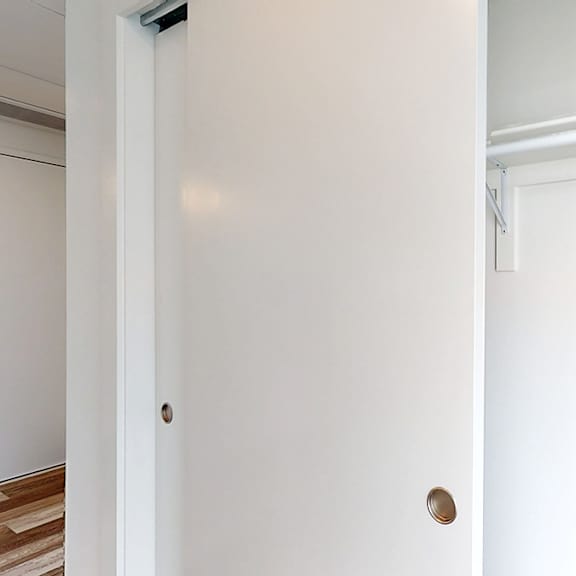 a white door with a handle is open.