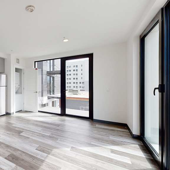 a modern kitchen with a dining area and a view of the city.