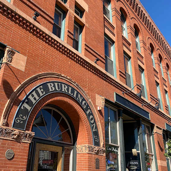 exterior brick facade of the burlington apartments showing  main entry door.