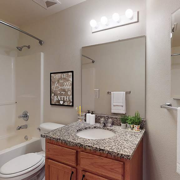 a bathroom with a toilet, sink, and shower.