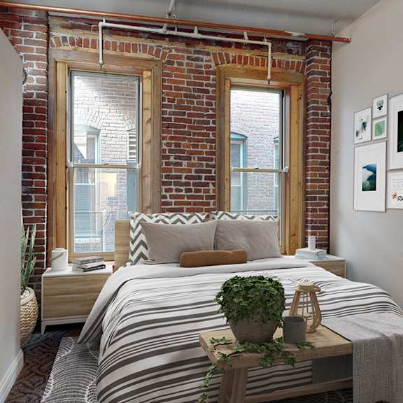 a bedroom with a bed, a window, and pictures on the wall.