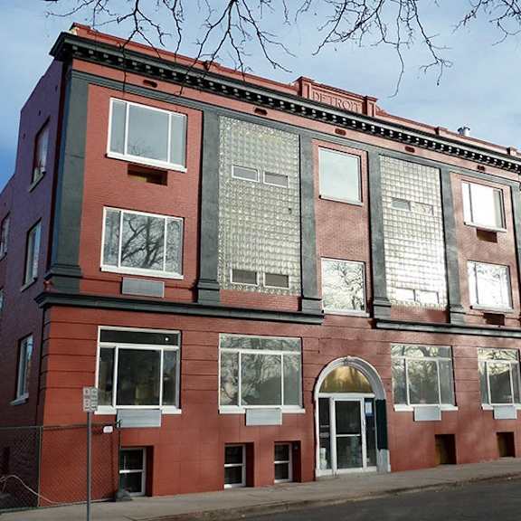 a red brick building with white trim and windows.